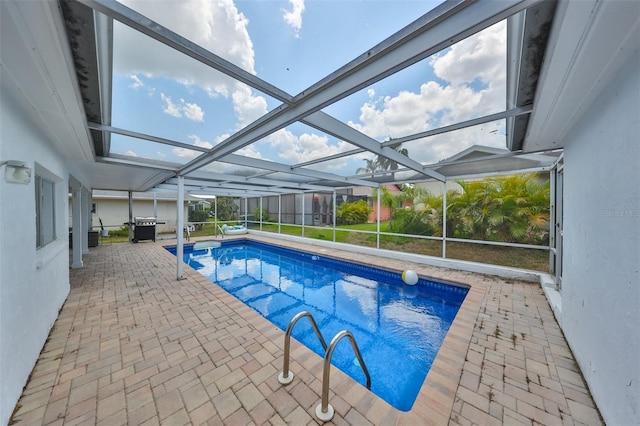 view of swimming pool with a patio and a lanai