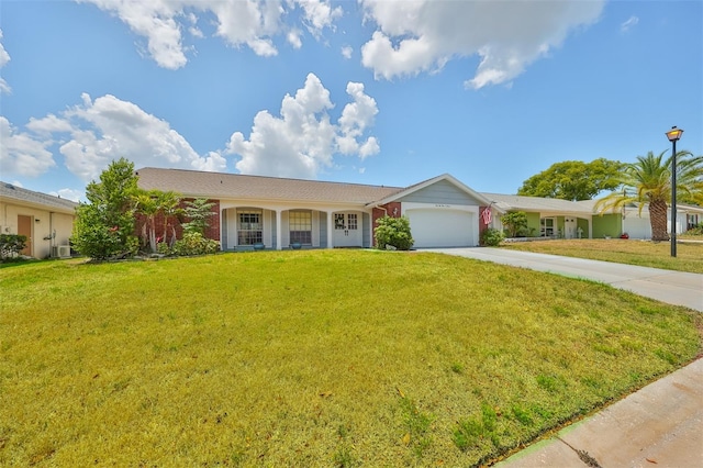 ranch-style house featuring a garage and a front lawn