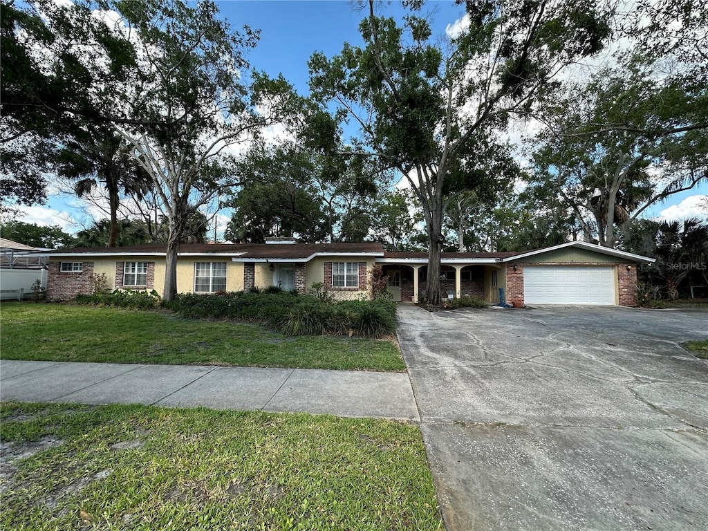 ranch-style house with a front yard and a garage