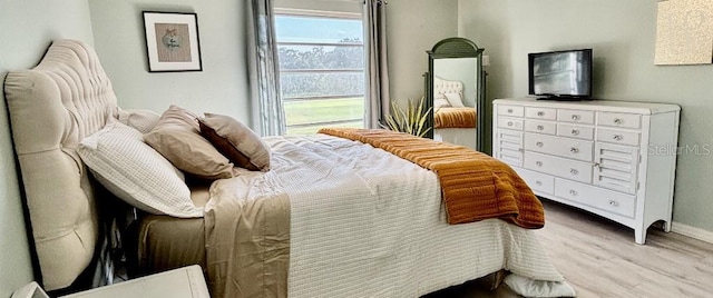 bedroom with light hardwood / wood-style flooring and multiple windows