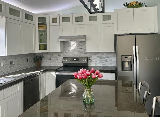 kitchen with backsplash, appliances with stainless steel finishes, white cabinets, and lofted ceiling