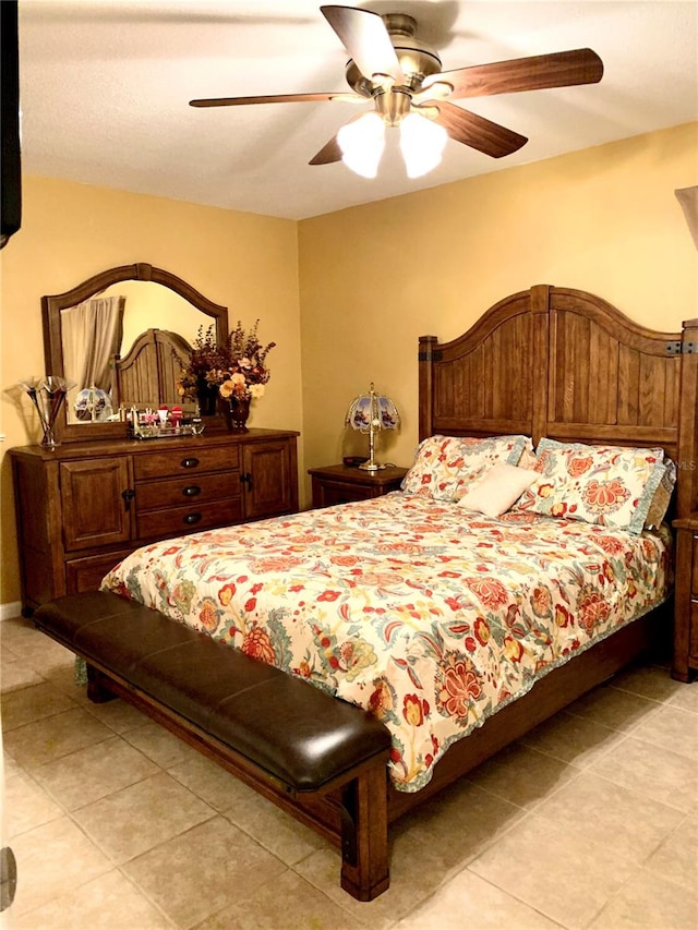 tiled bedroom with ceiling fan