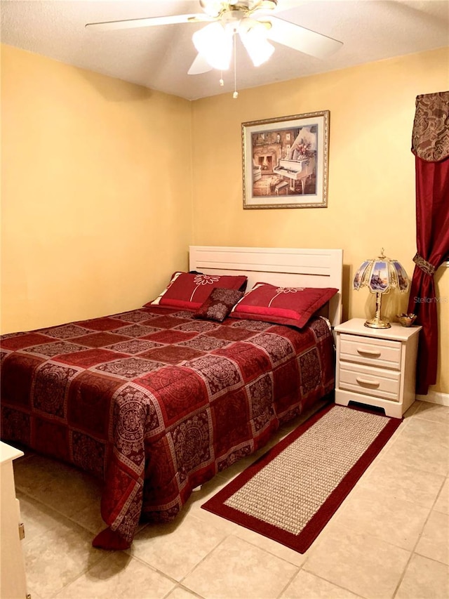 bedroom with ceiling fan and light tile flooring