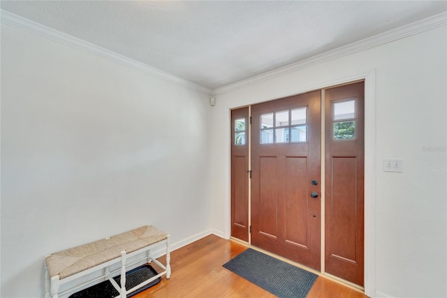 foyer featuring ornamental molding and wood-type flooring