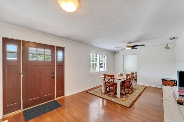 dining space with plenty of natural light, ceiling fan, hardwood / wood-style flooring, and a textured ceiling