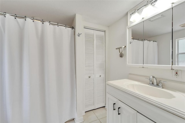 bathroom with oversized vanity and tile flooring