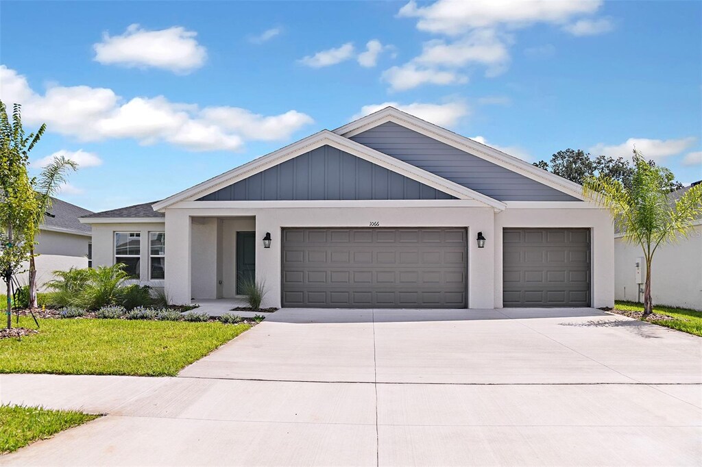 view of front facade with a garage and a front lawn