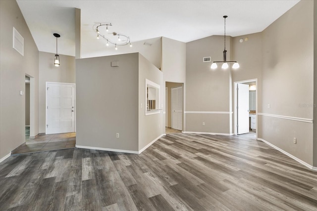 empty room featuring dark hardwood / wood-style floors and a high ceiling