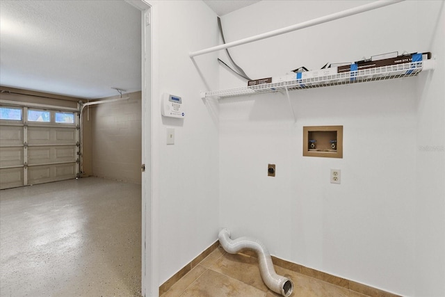 washroom with hookup for an electric dryer, washer hookup, and a textured ceiling