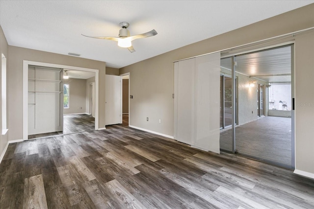 spare room featuring dark hardwood / wood-style floors and ceiling fan