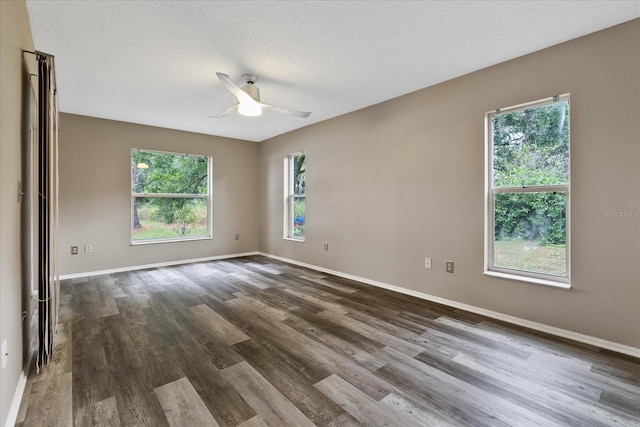 unfurnished room with dark hardwood / wood-style flooring, ceiling fan, and a textured ceiling