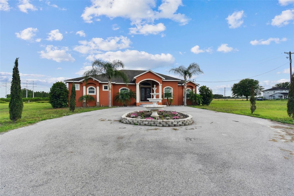 ranch-style house with a front lawn