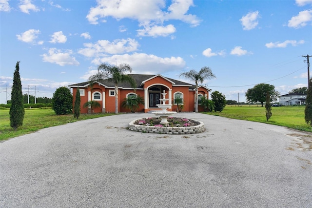 ranch-style house with a front lawn