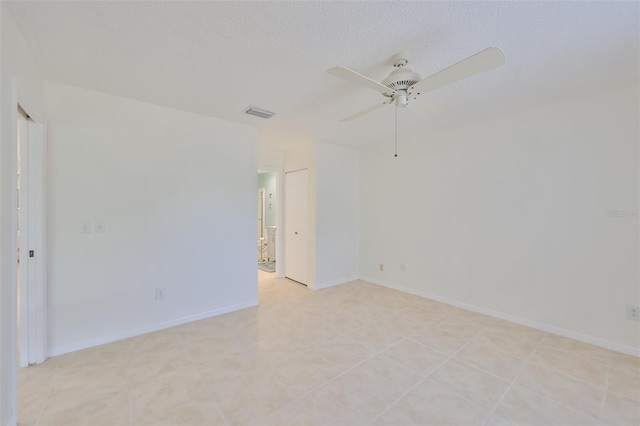 empty room with ceiling fan and light tile patterned flooring