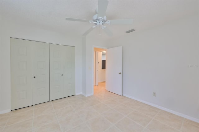 unfurnished bedroom featuring ceiling fan, a closet, and light tile patterned flooring