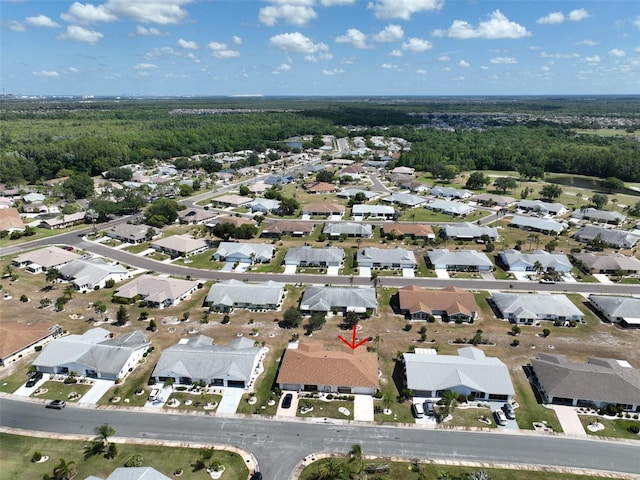 drone / aerial view with a residential view and a view of trees