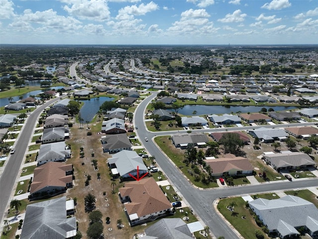 drone / aerial view featuring a residential view and a water view