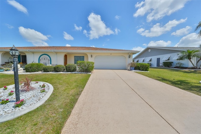 view of front of property with a front yard, concrete driveway, an attached garage, and stucco siding