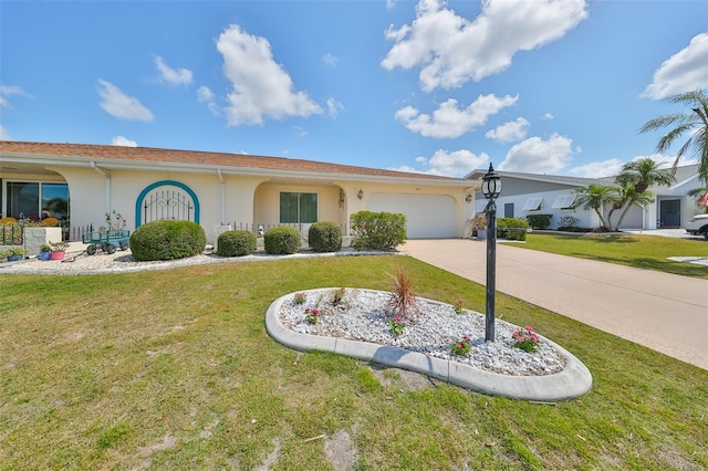 view of front of home featuring a front yard, concrete driveway, an attached garage, and stucco siding