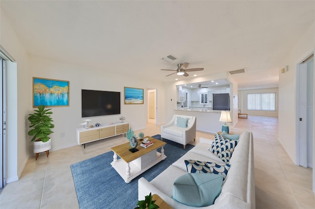 tiled living room featuring ceiling fan