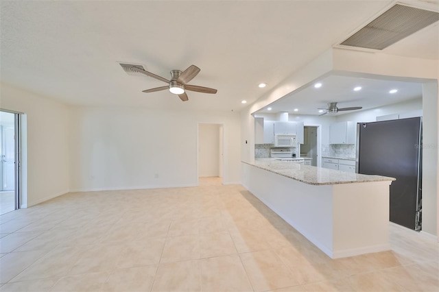 kitchen featuring ceiling fan, decorative backsplash, white cabinetry, kitchen peninsula, and white appliances