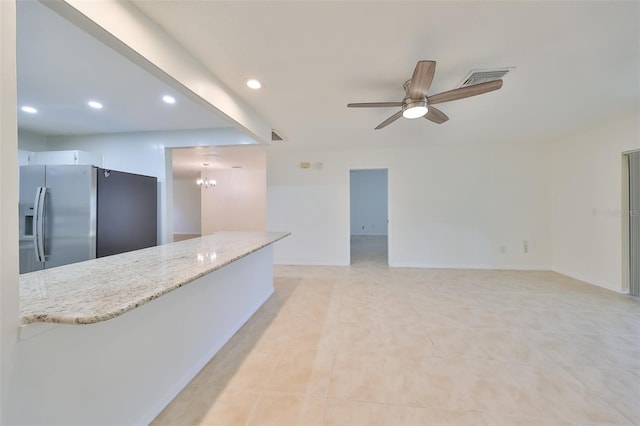 living room with ceiling fan with notable chandelier and light tile patterned floors