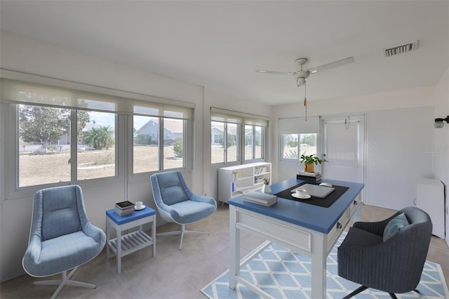 sunroom / solarium with a ceiling fan and visible vents