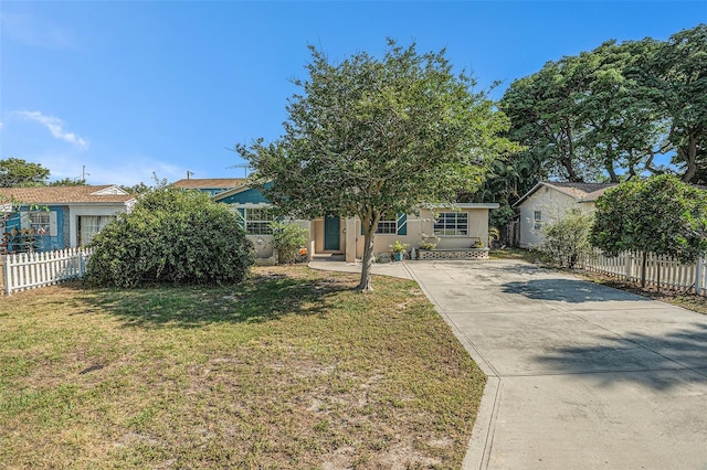 view of property hidden behind natural elements featuring a front yard