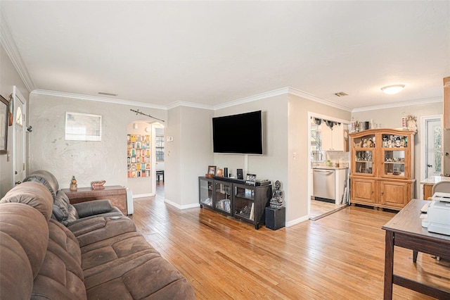 living room with light hardwood / wood-style floors and crown molding