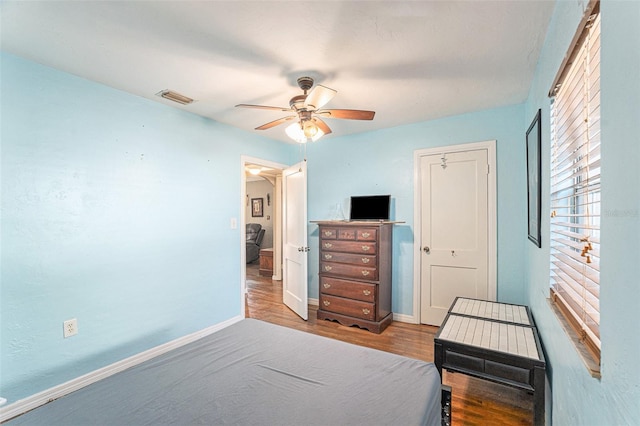 bedroom with hardwood / wood-style floors and ceiling fan