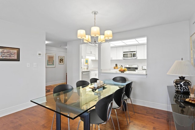 dining space with dark hardwood / wood-style flooring and a chandelier