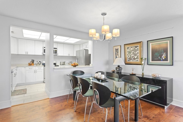 dining space with dark hardwood / wood-style flooring and a chandelier