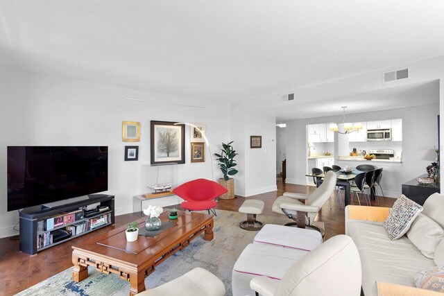 living room featuring hardwood / wood-style flooring and a chandelier