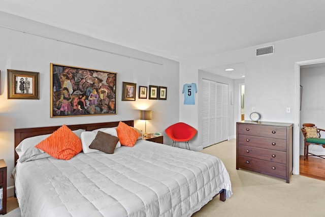 bedroom with light colored carpet and a closet