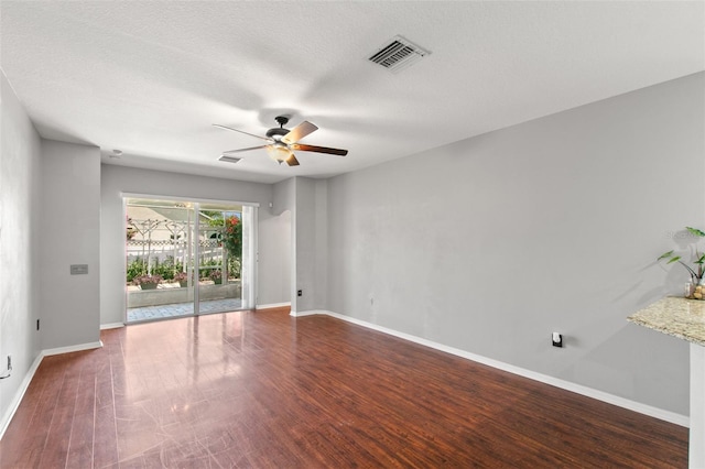 unfurnished room with dark hardwood / wood-style floors, ceiling fan, and a textured ceiling