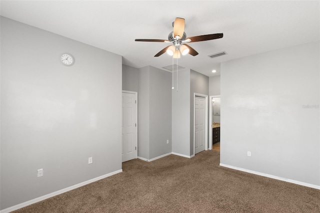 carpeted spare room featuring ceiling fan