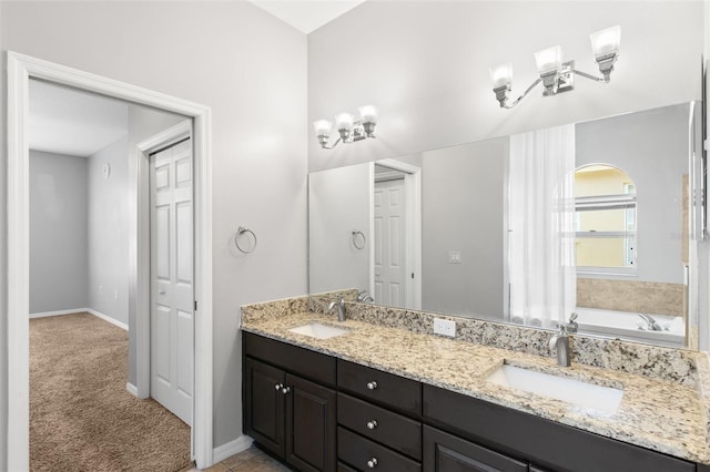 bathroom featuring a bath to relax in, vanity with extensive cabinet space, and dual sinks