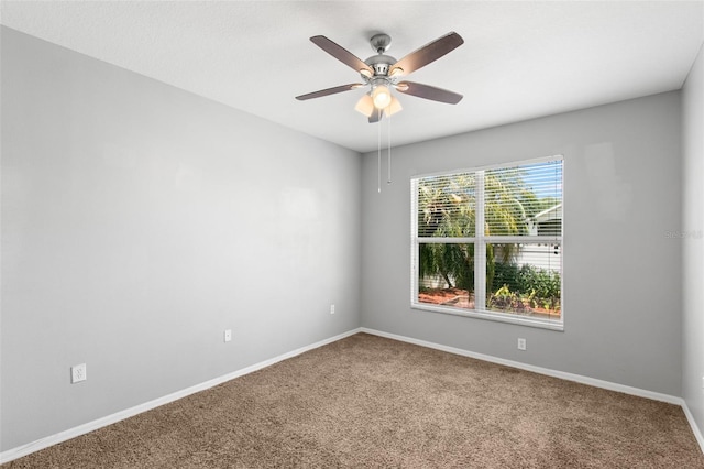 unfurnished room with ceiling fan and carpet flooring