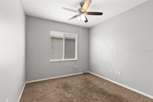 spare room with ceiling fan, a wealth of natural light, and carpet floors