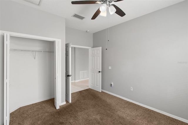 unfurnished bedroom with a closet, ceiling fan, and carpet flooring