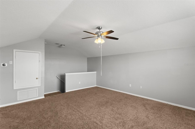 additional living space with lofted ceiling, ceiling fan, and carpet flooring