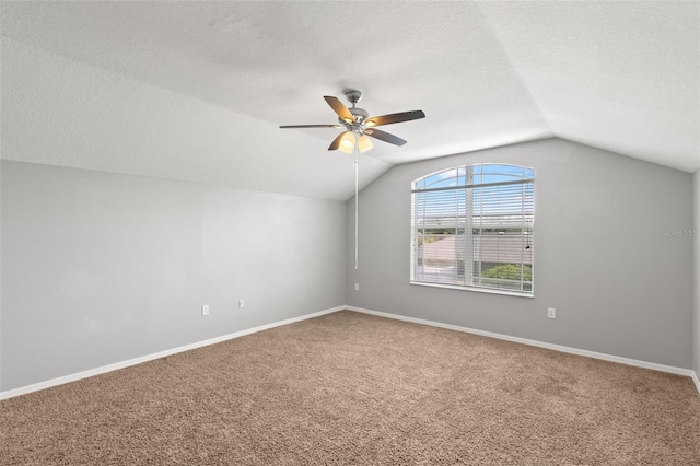 bonus room featuring ceiling fan, vaulted ceiling, carpet, and a textured ceiling