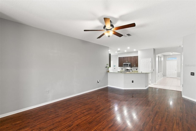 unfurnished living room featuring ceiling fan and light tile flooring