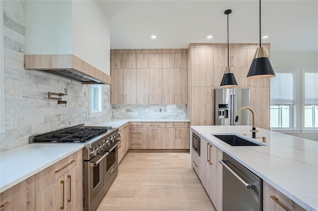 kitchen featuring high quality appliances, custom range hood, light stone counters, sink, and tasteful backsplash