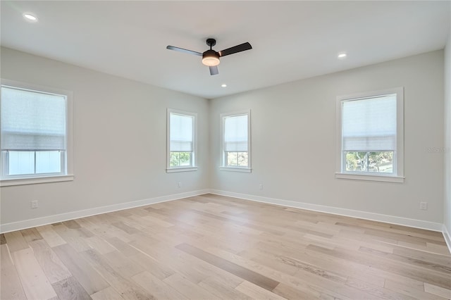 spare room featuring ceiling fan and light hardwood / wood-style floors