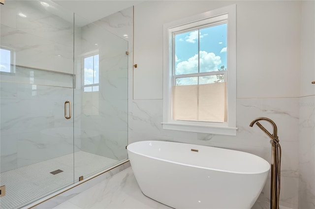 bathroom with tile floors, independent shower and bath, a wealth of natural light, and tile walls