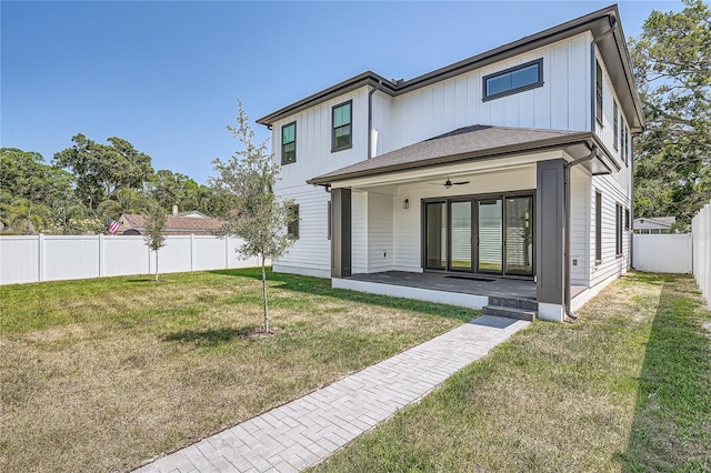 back of property featuring a lawn and a patio