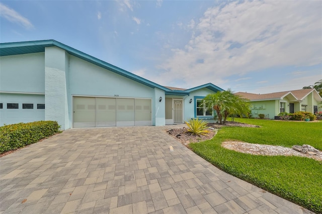 ranch-style home with a front yard and a garage