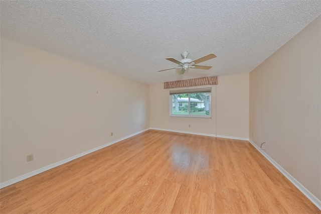 unfurnished room featuring light hardwood / wood-style flooring, ceiling fan, and a textured ceiling