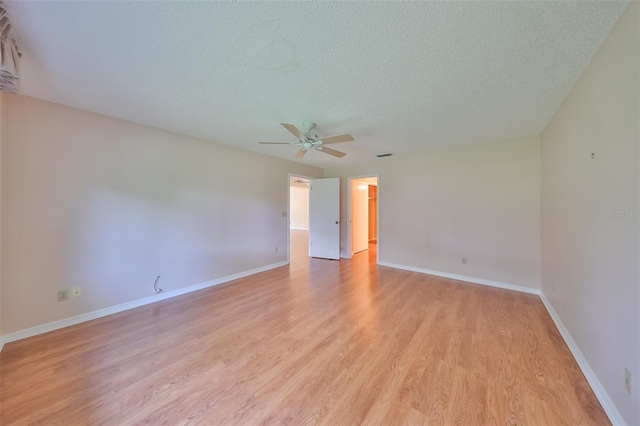 empty room with light hardwood / wood-style flooring, ceiling fan, and a textured ceiling